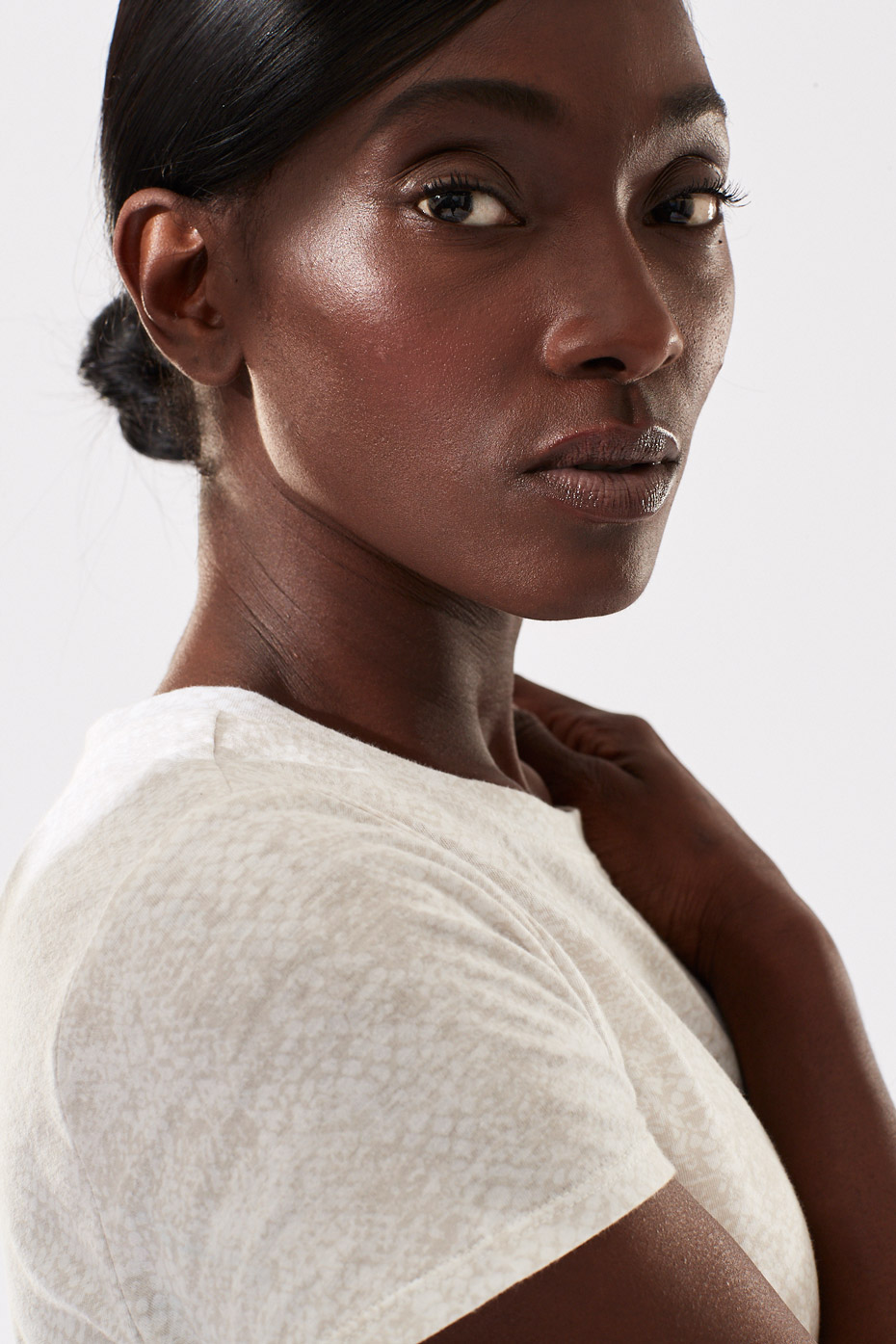 Strong Portrait of Black Female Model with Highlight on her face Photo by Shane O